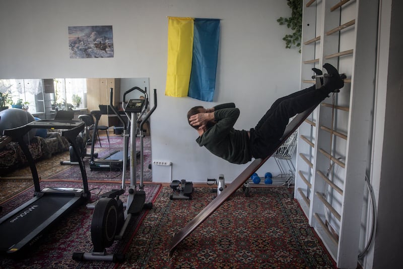 Leonid, a 38-year-old Ukrainian soldier suffering from severe mental trauma, cranial trauma and shrapnel wounds, does his physical training session at a psychiatric hospital in Kyiv, in October 2023. Getty Images