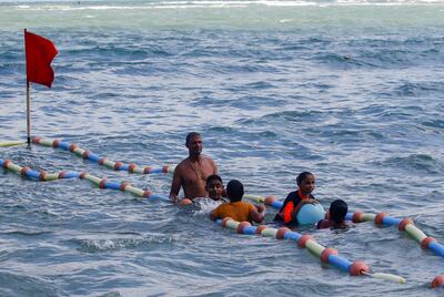 A lifeguard helps visually impaired children swim at Al Mandara beach on the Mediterranean coast in Alexandria. Reuters