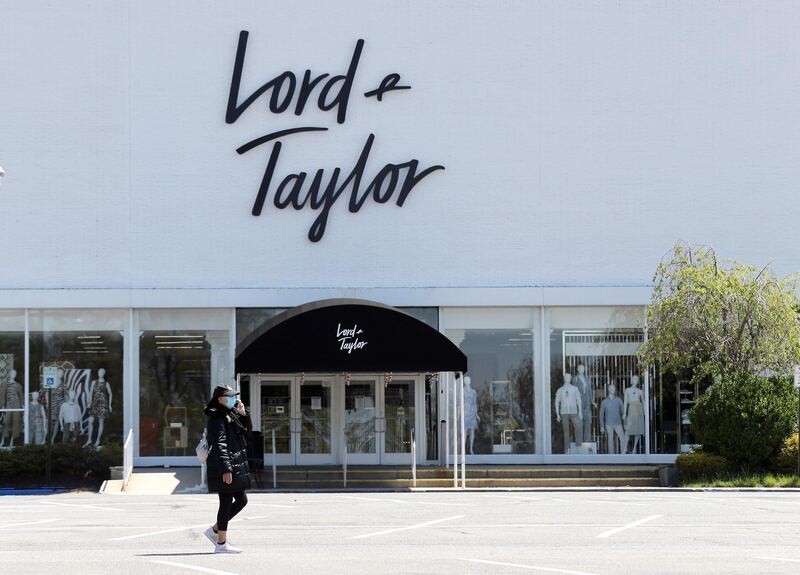 GARDEN CITY, NEW YORK - MAY 12: A pedestrian walks past a shuttered Lord and Taylor department store following their filing for bankruptcy amid the COVID-19 pandemic on May 12, 2020 in Garden City, New York.   Bruce Bennett/Getty Images/AFP