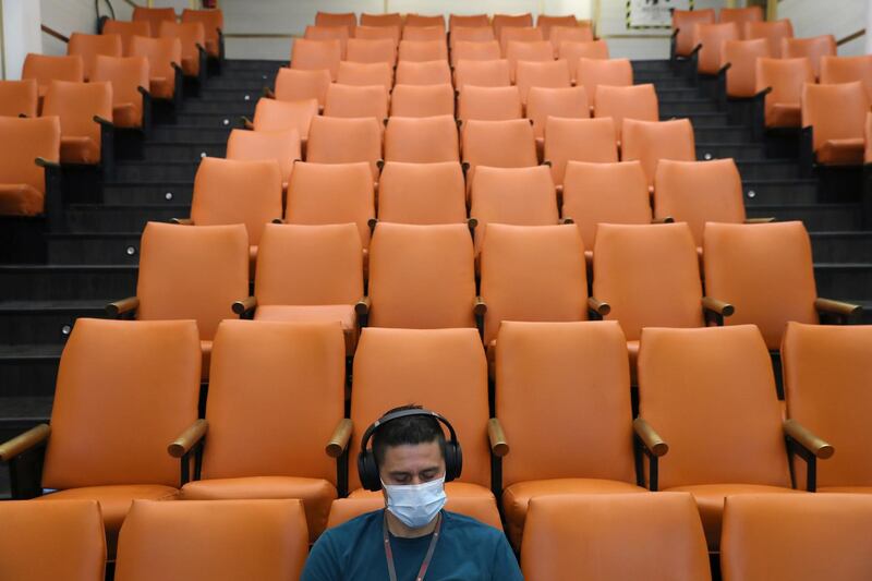 A healthcare worker sits inside a monitoring room after receiving a second dose of the Pfizer/BioNTech vaccine at the Posta Central hospital in Santiago, Chile. Reuters