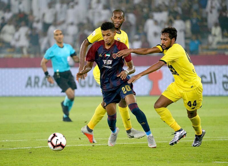 Yahya Al Ghassani tussles for the ball with Al Wasl’s Ahmed Salem Al Farsi (yellow) Courtesy Al Wahda.