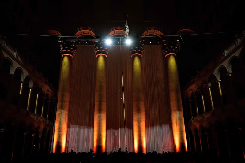 French high-wire artist Philippe Petit performs during a fundraiser at the National Building Museum in Washington. AFP