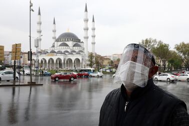 A man wearing a face shield for protective measures crosses the streets as the spread of the novel coronavirus (Covid-19) continues in the Turkish capital Ankara. AFP