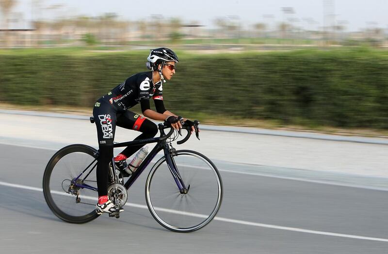 Emirati Masooma Ali cycles at the Al Khawaneej cycle track during the evening in Dubai. Pawan Singh / The National