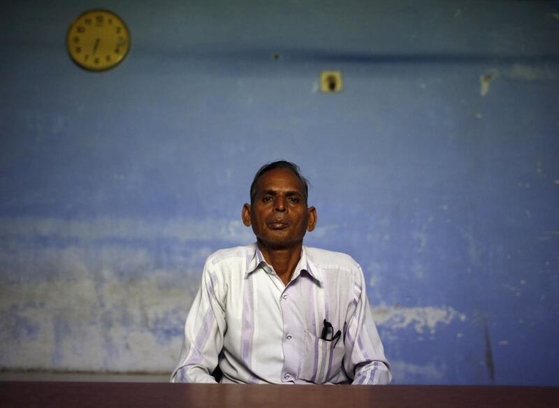 Nazirkhan Pathan, a Muslim school teacher who survived the 2002 Gujarat riots, sits inside a school.