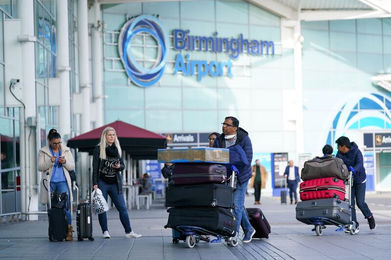 Passengers arrive at Birmingham Airport on Monday morning, as travel between the UK and dozens of countries reopened after the government lifted restrictions. PA