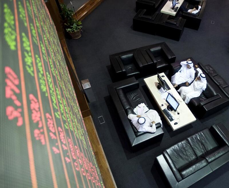 UAE stock markets have risen almost 90 per cent over the past 12 months. Above, traders at the Dubai Financial Market. Charles Crowell for The National