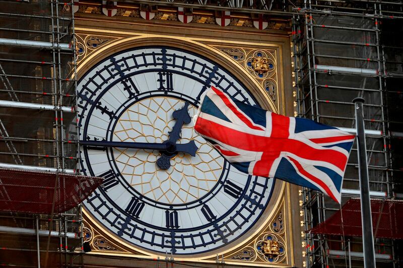 The Union flag flutters near the clockface of Big Ben during ongoing renovations to the Tower and the Houses of Parliament, in central London on January 7, 2020. / AFP / Adrian DENNIS

