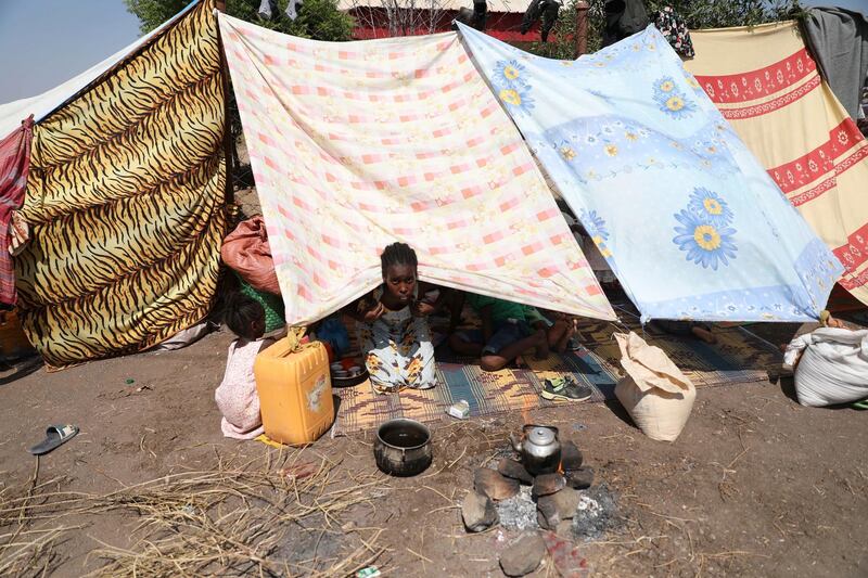A young refugee from the Tigray region of Ethiopia waits to register at the UNCHR centre at Hamdayet, Sudan.  AP Photo