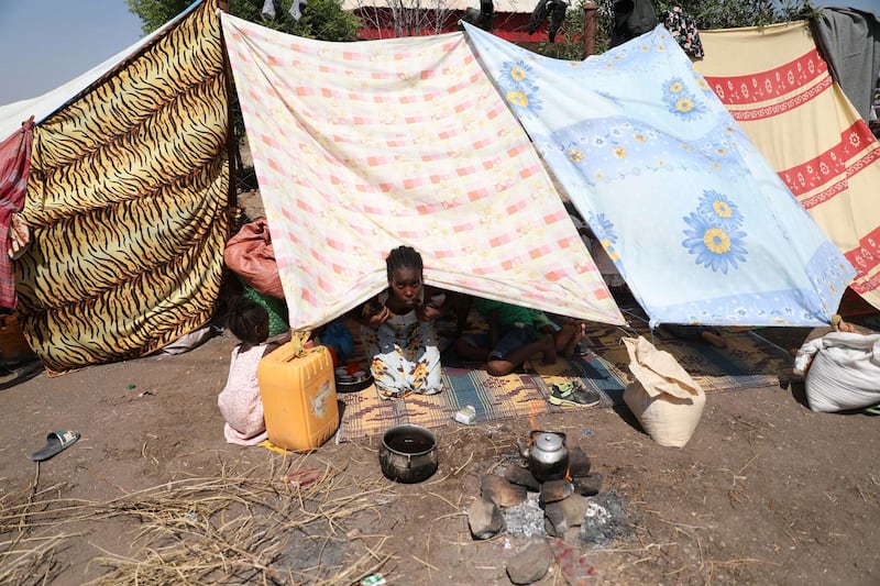 A young refugee from the Tigray region of Ethiopia waits to register at the UNCHR center at Hamdayet, Sudan.  AP