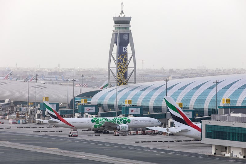 Passenger aircraft operated by Emirates stand beside the terminal building at Dubai International Airport in Dubai during March. All photos by Bloomberg