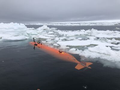 A robotic vehicle with imaging sensors, on sea ice in front of Thwaites Glacier, after a mission to map the seafloor. PA