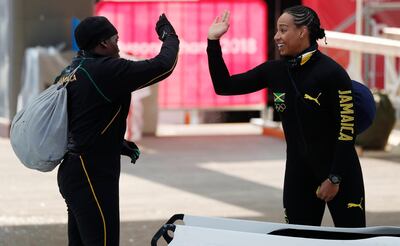 Bobsleigh – Pyeongchang 2018 Winter Olympics – Women’s Training – Olympic Sliding Centre - Pyeongchang, South Korea – February 8, 2018 - Jazmine Fenlator-Victorian and Carrie Russell of Jamaica trade high-fives.  REUTERS/Edgar Su