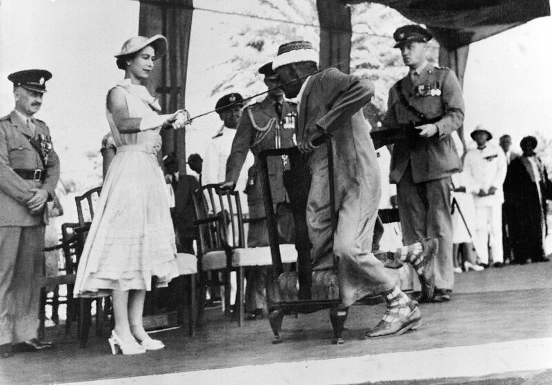 Yemen councillor Sayyid Abubakr bin Shaikh Alkaff kneels before Queen Elizabeth II to be knighted in Aden on April 29, 1954. AFP