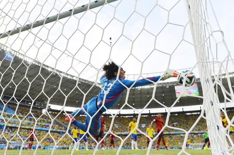 Mexico goalkeeper Guillermo Ochoa dives for the ball during his side's 2014 World Cup Group A match with Brazil on Tuesday, which ended in a 0-0 draw. Yuri Cortez / AFP / June 17, 2014  