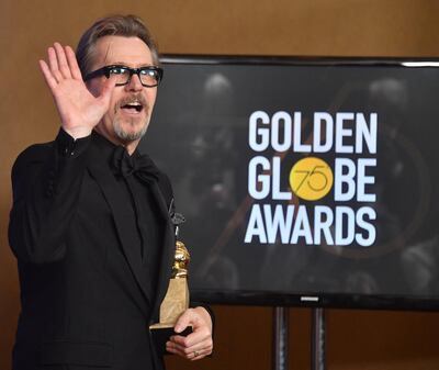 Actor Gary Oldman poses with the trophy for Best Performance by an Actor in a Motion Picture - Drama during the 75th Golden Globe Awards on January 7, 2018, in Beverly Hills, California. / AFP PHOTO / Frederic J. BROWN