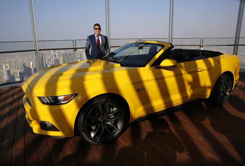 Ford chairman Bill Ford poses next to a Ford Mustang at the Burj Khalifa, the tallest building in the world, on Dubai November 19, 2014. Ahmed Jadallah / Reuters