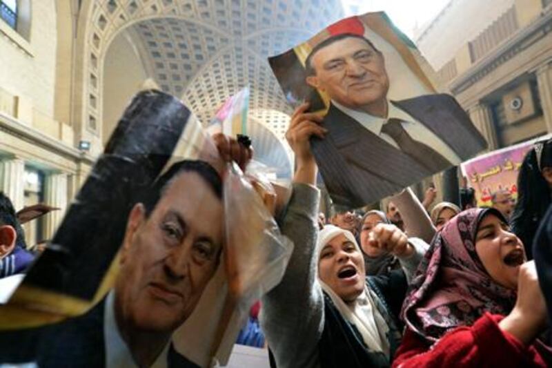 Egyptian supporters of former president Hosni Mubarak celebrate in Cairo after the top appeals court accepted an appeal for a retrial. AFP Photo / Khaled Desouki