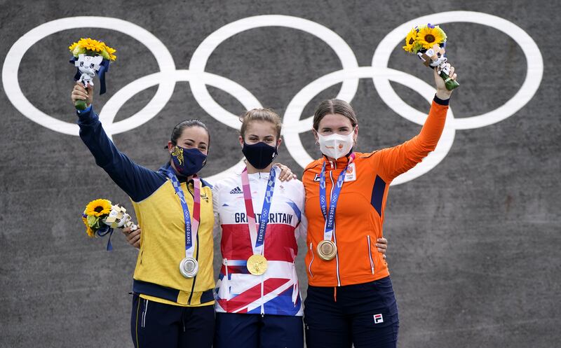 Great Britain's Bethany Shriever collects her gold medal alongside Colombia's Mariana Pajon (silver) and Netherlands' Merel Smulders (bronze) for the Cycling BMX Racing at the Ariake Urban Sports Park.