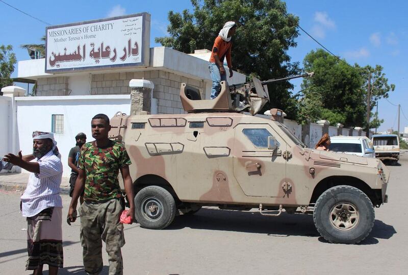 Yemeni security forces gather outside a home for the aged in Aden where 17 people were killed in attack by gunmen on March 4, 2016. Saleh Al Obeidi / AFP