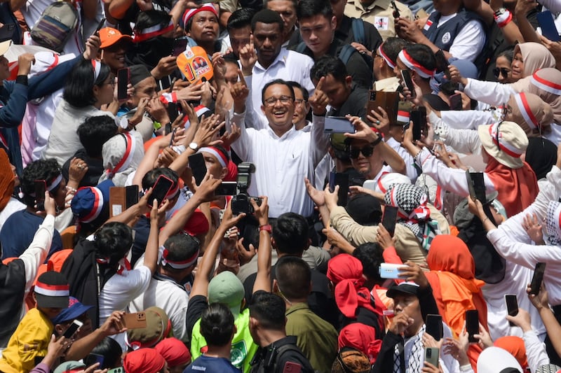 Indonesian presidential and vice presidential candidates, Anies Baswedan, centre, and Muhaimin Iskandar, rear centre, greet supporters during their campaign rally, in Jakarta. AFP
