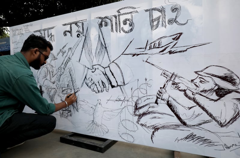An Indian artist draws a poster during a protest in Kolkata. EPA