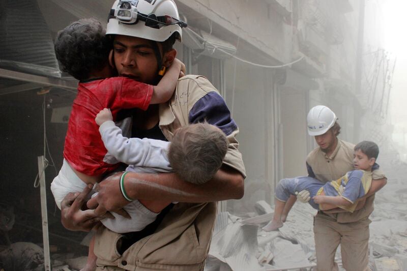 Members of the Civil Defence rescue children after what activists said was an air strike by forces loyal to Syria's President Bashar al-Assad in al-Shaar neighbourhood of Aleppo June 2, 2014. REUTERS/Sultan Kitaz   (SYRIA - Tags: POLITICS CIVIL UNREST CONFLICT TPX IMAGES OF THE DAY) - GM1EA621EWW01