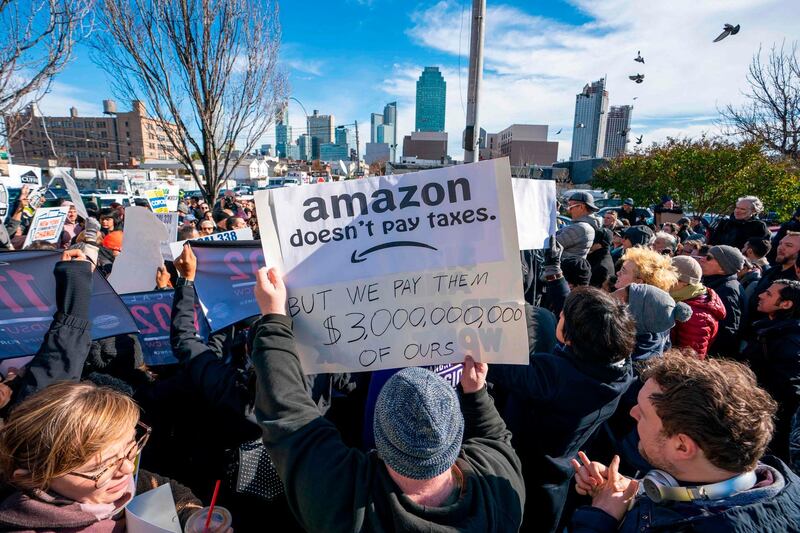 Protesters gather in Long Island City to say "No" to the Amazon "HQ2" decision on November 14, 2018 in Long Island City, New York.                           It's exciting for some, worrisome for others: The arrival of a massive headquarters of technology giant Amazon in two East Coast communities is certain to bring huge changes.
Amazon announced Tuesday after a yearlong search that it would split its "HQ2" between Arlington, Virginia, outside the US capital, and the Long Island City neighborhood in the New York borough of Queens.
 / AFP / Don EMMERT
