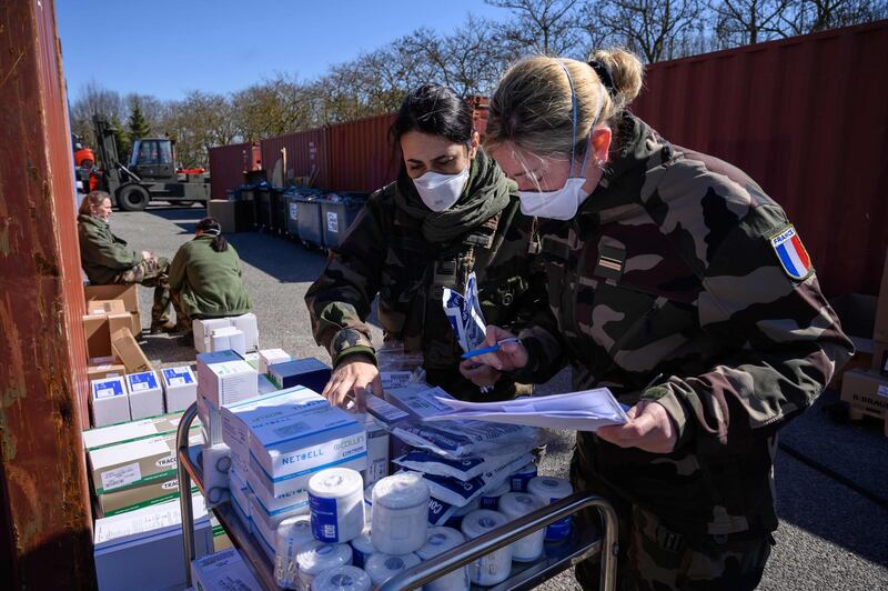 French soldiers prepare medical gear during the setting up of an intensive care unit at a military field hospital at the Emile Muller Hospital in Mulhouse, eastern France. AFP
