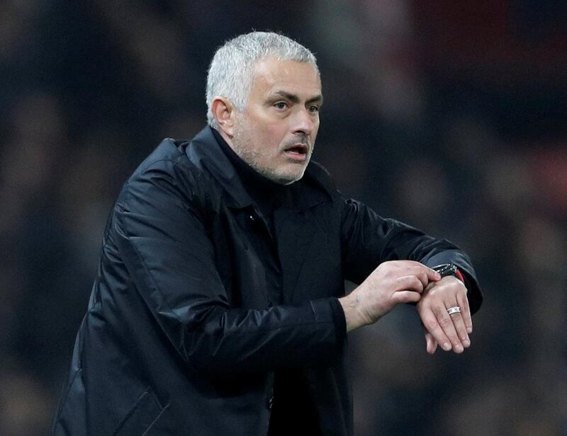 Manchester United manager Jose Mourinho checks his watch as the signal goes up for four minutes of added time. Reuters