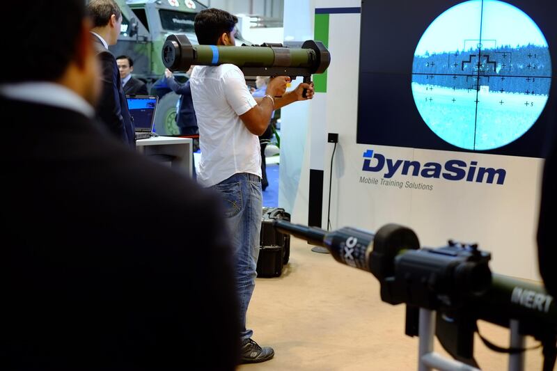 ABU DHABI, UNITED ARAB EMIRATES - - -  February 18, 2013 ---  Rineesh Raghunath takes aim with a DynaSim by Dynamit Nobel Defence of Germany during the second day at IDEX.    ( DELORES JOHNSON / The National )
