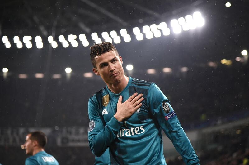 (FILES) In this file photo taken on April 03, 2018 (FILES) In this file photo taken on April 03, 2018 Real Madrid's Portuguese forward Cristiano Ronaldo celebrates his second goal during the UEFA Champions League quarter-final first leg football match between Juventus and Real Madrid at the Allianz Stadium in Turin. Spain's media said goodbye to superstar Cristiano Ronaldo while Italy's welcomed him on July 6, 2018 after persistent reports that the five-time Ballon d'Or winner will leave Real Madrid for Italian champions Juventus. / AFP / Marco BERTORELLO                    
