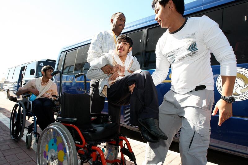 

DUBAI, UNITED ARAB EMIRATES Ð Jan 24,2011: Staff members helping the wheelchair bound children into the bus after the school time at Dubai Center for Special Needs in Dubai. (Pawan Singh / The National) For News.