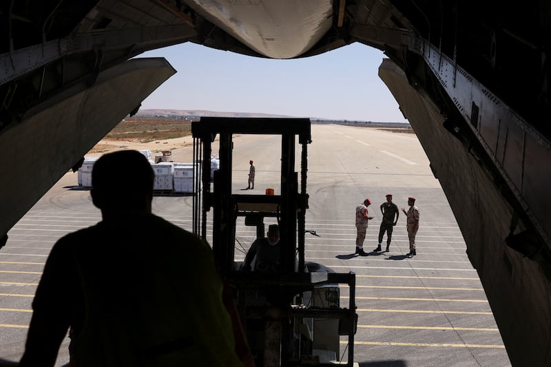 Libyan military officers and workers unload relief items.  Reuters