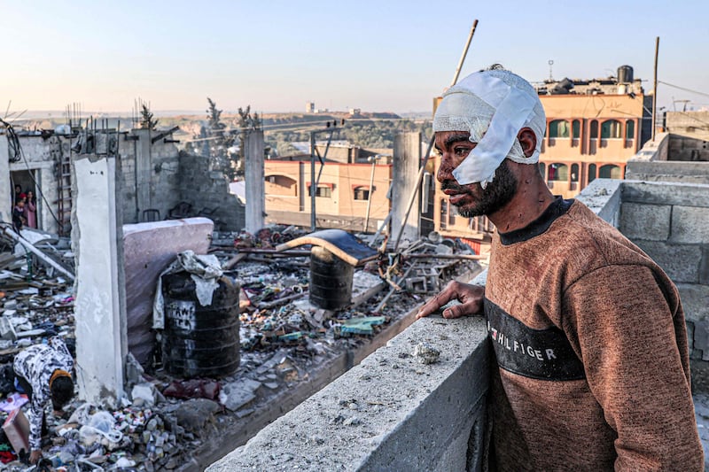 A wounded Palestinian looks at buildings destroyed by Israeli bombs in Rafah, the southern Gaza Strip. AFP