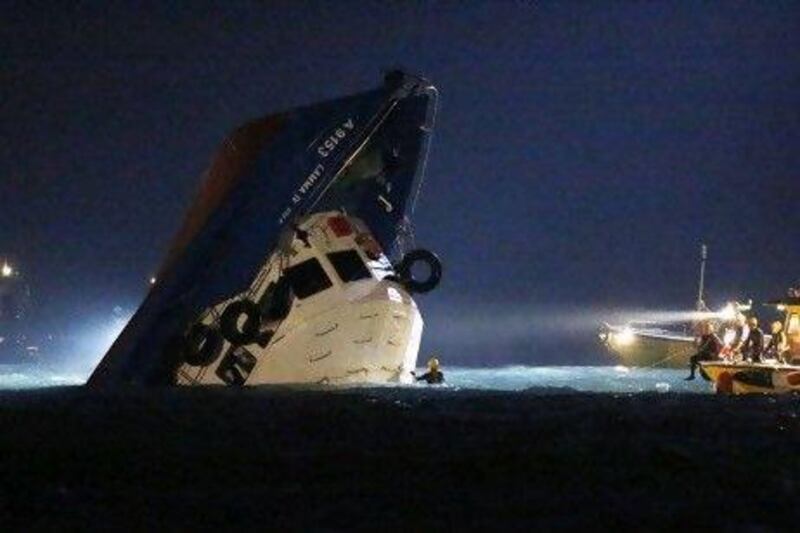 Rescuers patrol near a half-submerged boat after it collided with a ferry near Lamma Island off the south-western coast of Hong Kong Island.