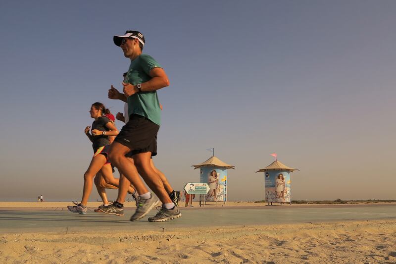 Dubai, United Arab Emirates - May 20, 2016.  Joggers make use of the good rubberized pathways reserved for them, just along the beach.  ( Jeffrey E Biteng / The National )  Editor's note;  STANDALONE *** Local Caption ***  JB200516-Beach15.jpg