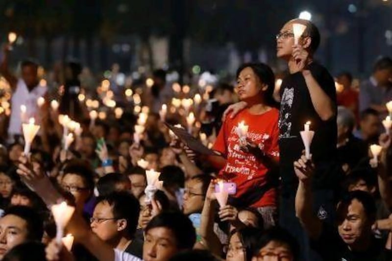 People attend a candlelight vigil at Hong Kong's Victoria Park today to mark the 23rd anniversary of the Chinese military crackdown on the pro-democracy movement in Beijing. Kin Cheung / AP Photo