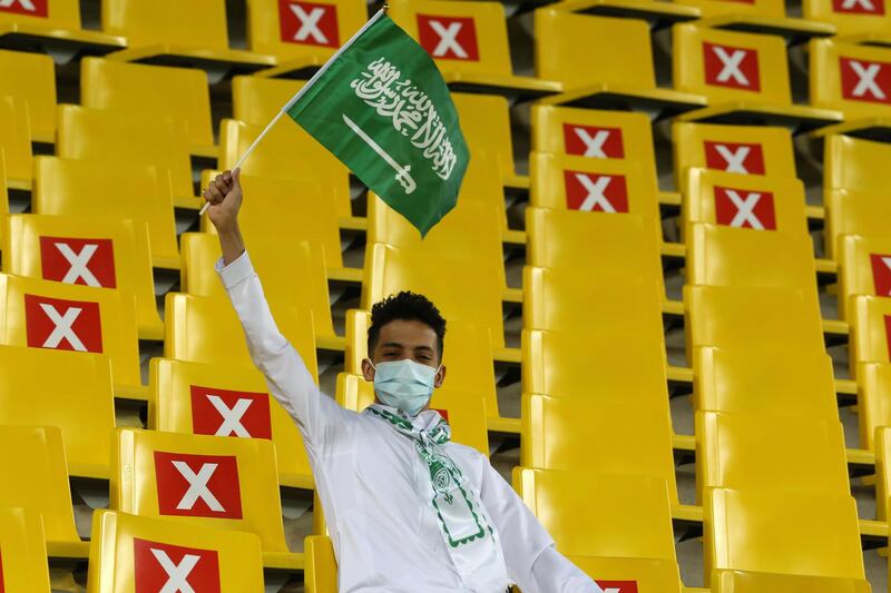 A Saudi Arabia fan waves a flag inside the stadium before the World Cup qualifier. Reuters