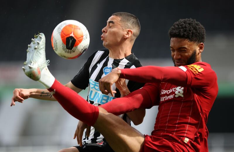 Liverpool defender Joe Gomez, right, battles for possession with Miguel Almiron of Newcastle during the Premier League match at St James' Park on Sunday, July 26. Reuters