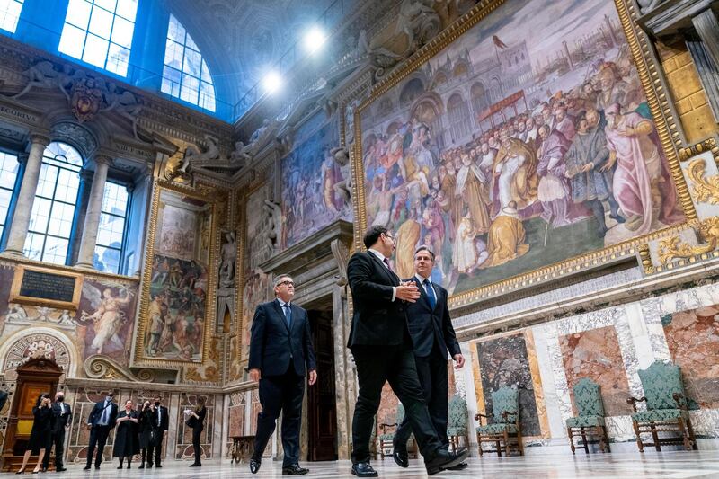 Secretary of State Antony Blinken, right, accompanied by tour guide Alessandro Conforti, second from right, and Chargé d'Affaires of the U.S. Embassy to the Holy See Patrick Connell, left, gets a tour of the Sala Regia at the Vatican in Rome. AP Photo