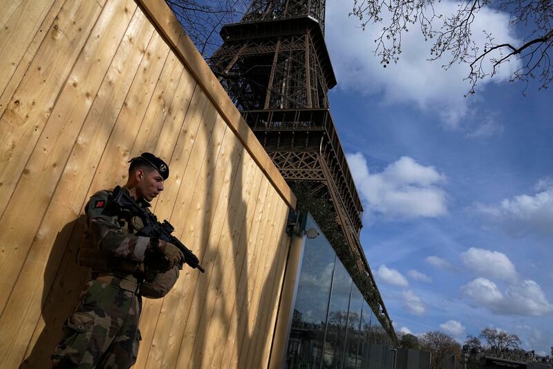 A soldier on patrol next to the Eiffel Tower in Paris. France increased its security alert warning to its highest level after the deadly attack at a Russian concert hall. AP