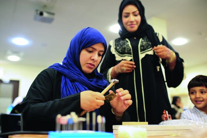 Azza Al Qubaisi (blue headscarf), founder of Back2Burqa, teaches an Islamic jewellery making class.