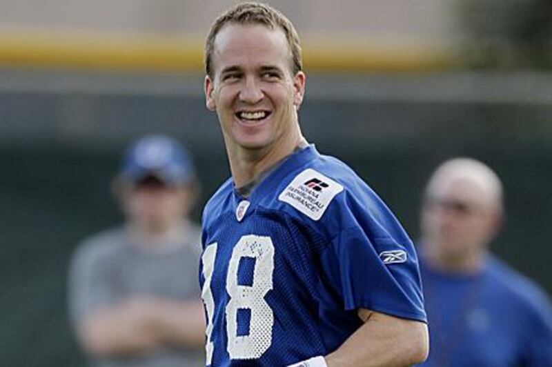 Peyton Manning warms up during training in Miami this week for today's Super Bowl.