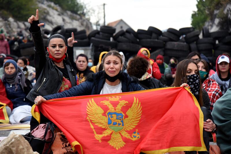 Demonstrators gather at a barricade set up to block access roads to the historic city of Cetinje during a protest against the inauguration of the new head of the Serbian Orthodox Church on September 5, 2021 in Montenegro.  - The new head of the Serbian Orthodox Church in Montenegro was inaugurated, arriving by helicopter under the protection of police who dispersed protesters with tear gas.  The decision to anoint Bishop Joanikije as the new Metropolitan of Montenegro at the historic monastery of Cetinje has aggravated ethnic tension in the tiny Balkan state.  (Photo by SAVO PRELEVIC  /  AFP)