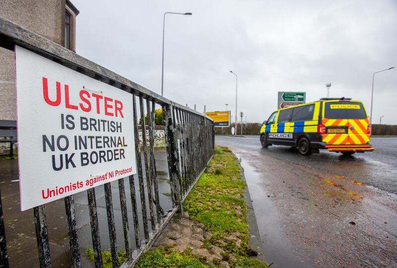 A placard reads "Ulster is British, No internal U.K. border" near the Port of Larne in Larne, U.K., on Thursday, Feb. 4, 2021. On Tuesday, U.K. Cabinet Office Minister Michael Gove condemned the EU's threat to impose border checks on Northern Ireland, warning it had provoked anger on all sides of the political divide. Photographer: Paul Faith/Bloomberg