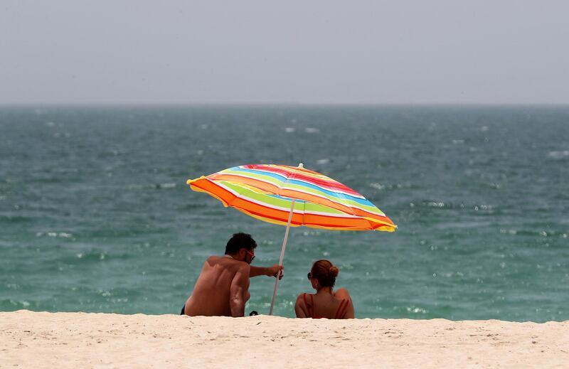 DUBAI, UNITED ARAB EMIRATES , June 27 – 2020 :- Visitors during the hot and humid weather at the Kite beach in Dubai. (Pawan Singh / The National) For Standalone