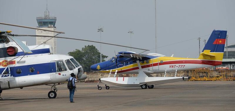 A sea plane, right, taxis as it prepares to take off for a search flight. Hoang Dinh Nam / AFP Photo March 9