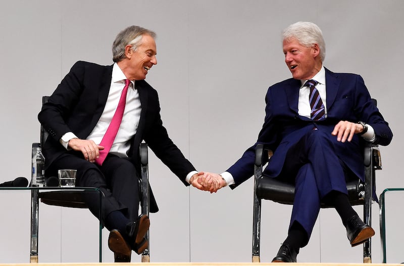 Mr Blair and Mr Clinton hold hands an event to celebrate the 20th anniversary of the Good Friday Agreement in Belfast, Northern Ireland, on April 10, 2018. Reuters