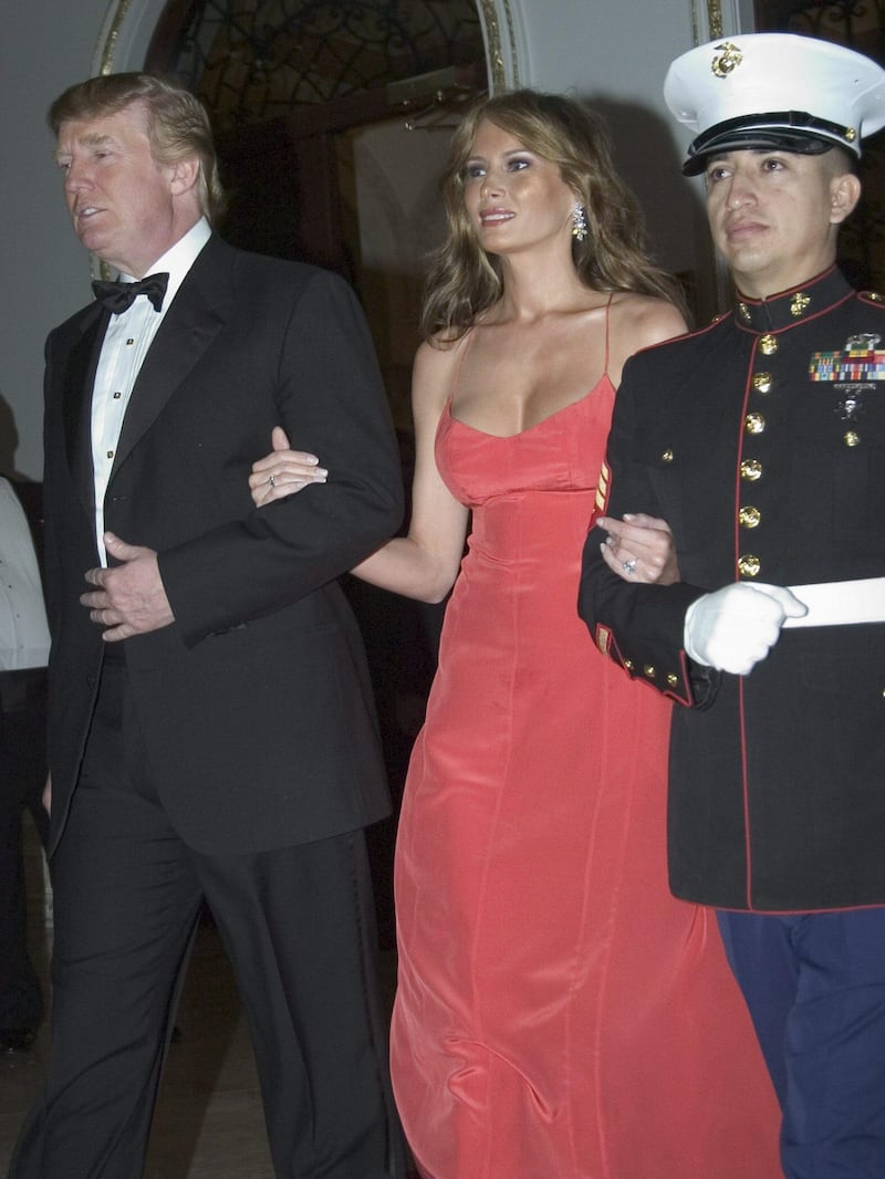 epa000358412 Donald Trump and his wife Melania are escort by a Marines as they attend  the International Red Cross Ball on Saturday 29 January 2005, in Palm Beach, Florida, USA. Founded by Marjorie Merriweather Post 48 years ago and held at her original residence and now Donald Trump's Mir-a-Largo Club. This event is benefiting the America Red Cross Greater West Palm Beach Area Chapter to provide relief and educational services throughout our community.  EPA/JOANNA GLEASON